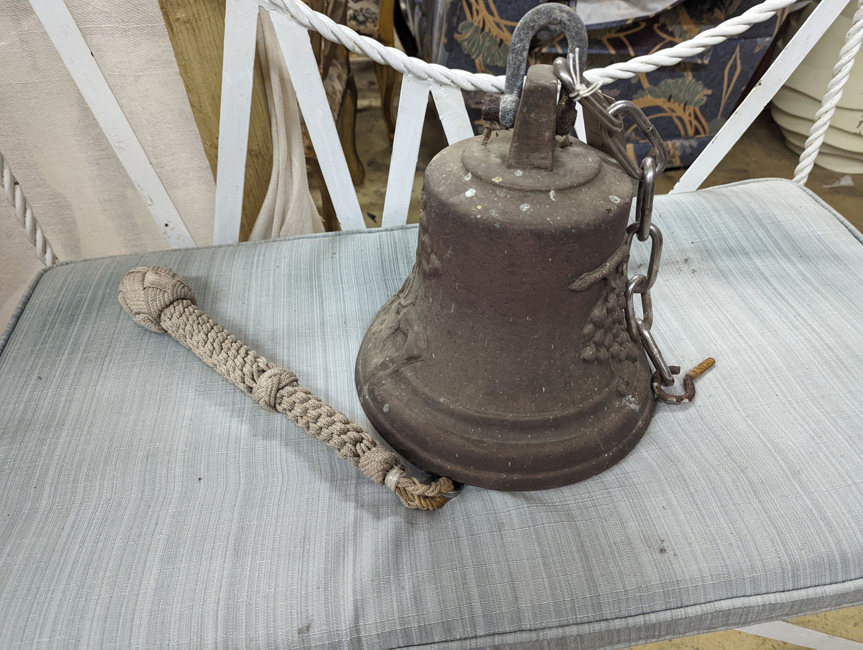 A cast metal bell moulded with deer and fruit, height 24cm